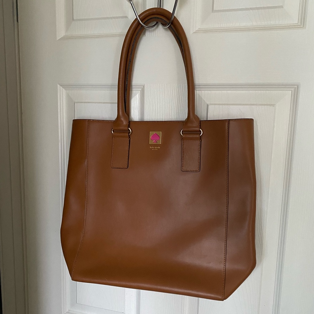 Kate Spade leather tote with monogrammed lining and bright pink interior edge